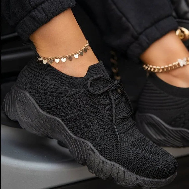 Women's chunky platform sneaker in a solid colour with a thick sole, shown from the side.