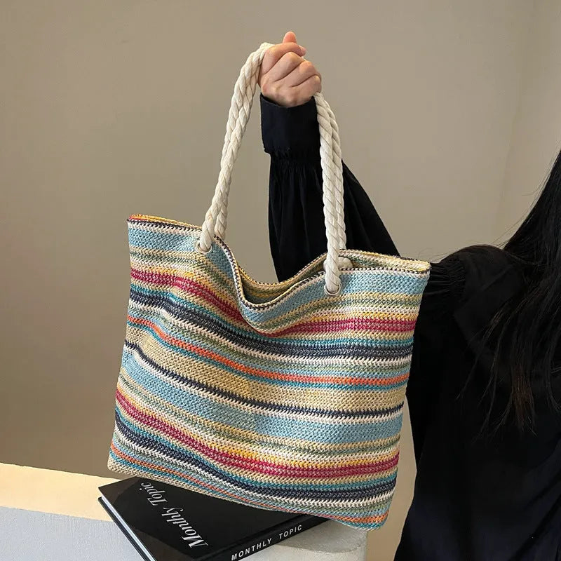 Blue woven nylon shoulder bag with straw-weave pattern and adjustable strap