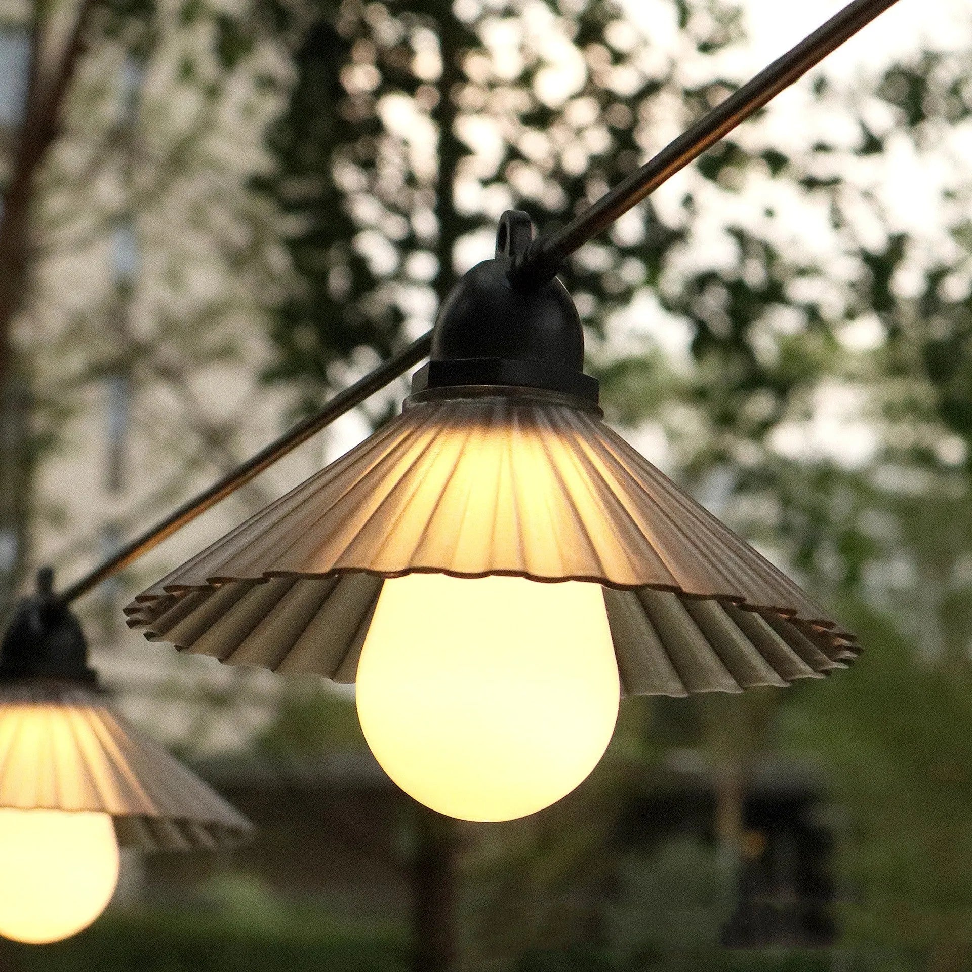 Outdoor LED string lights with flower-shaped bulbs in warm white and multi-colour options.