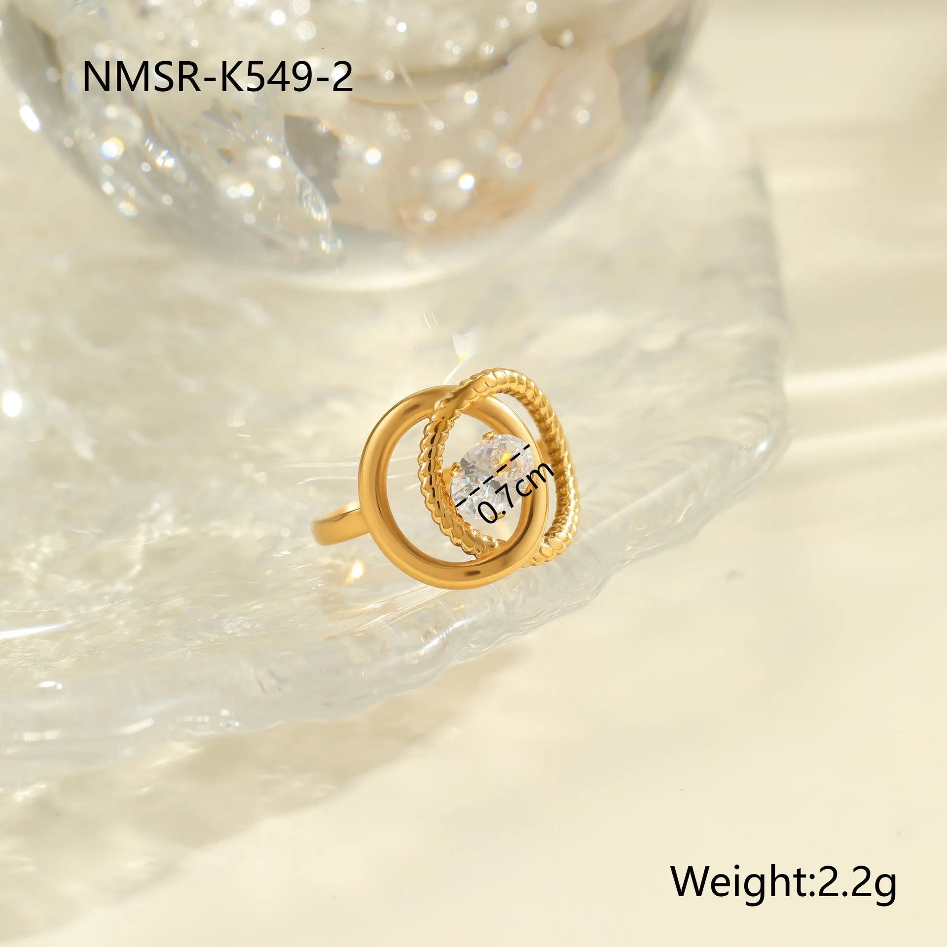 Gold electroplated adjustable ring with geometric zircon design on a stainless steel band.