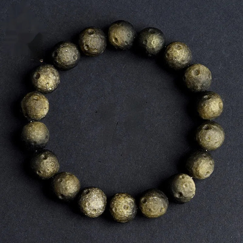Natural obsidian crater ball bracelet with meteorite texture in silver stone and gold obsidian colour variations