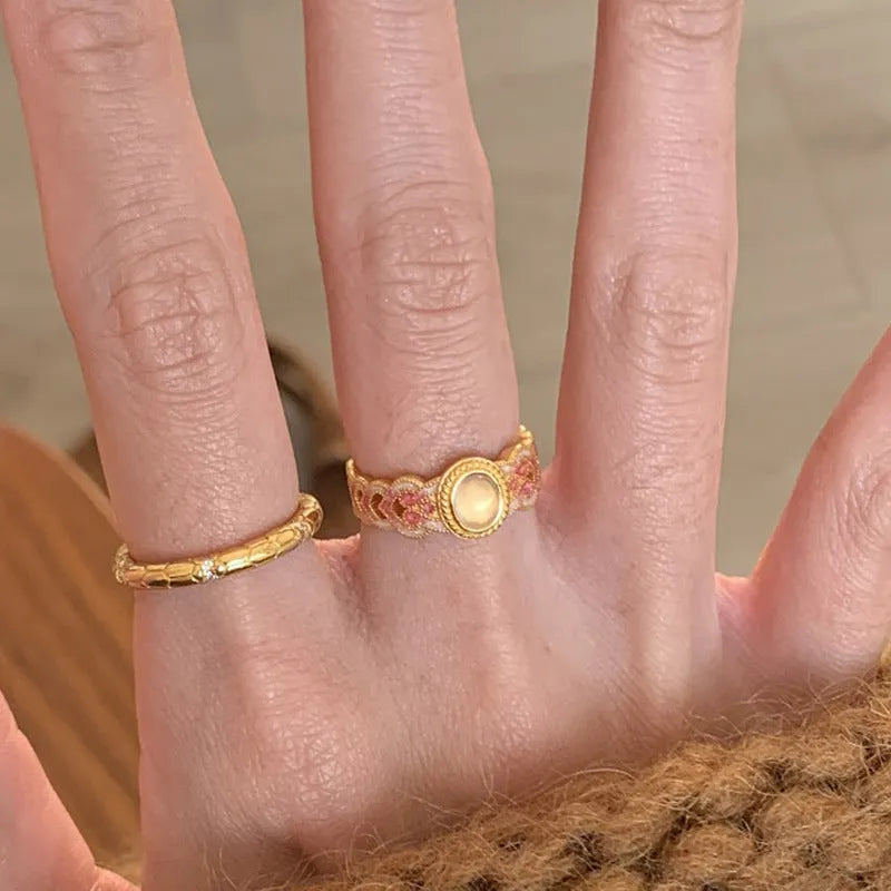 Geometric open ring for women in gold-plated copper with a pink crystal enamel detail.