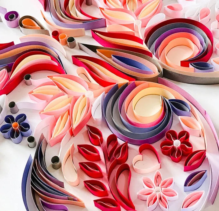 Handmade 20-inch Blue and Pink butterfly quilling paper craft kit with tools on a table