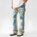 Yellow and blue retro patchwork jeans with splash-ink distressed design and zip fly.