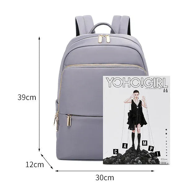 Large black oxford cloth women's backpack with anti-theft compartments and padded straps.