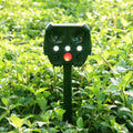Green solar-powered ultrasonic animal repeller unit for outdoor pest and dog control.