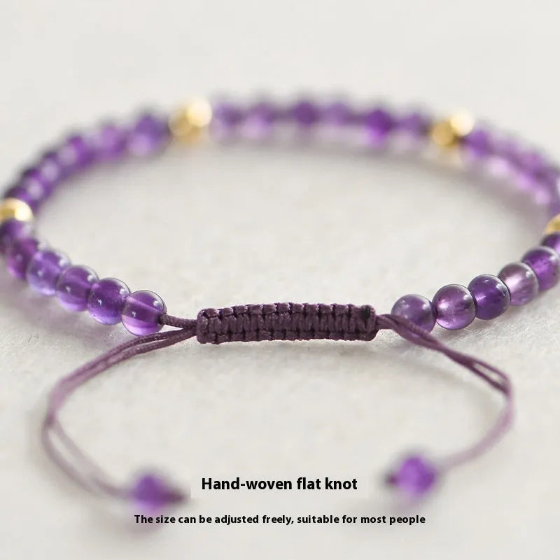 Handmade purple amethyst and 14K gold bracelet with 4mm round beads on a wrist.