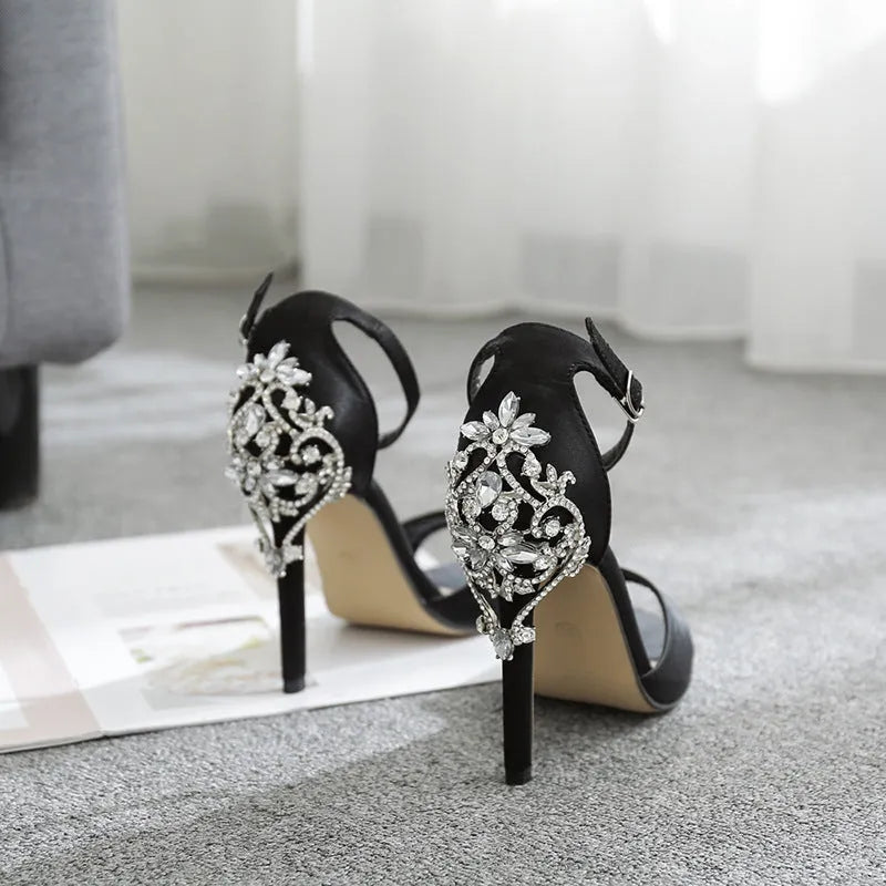 Black suede women's high heel shoes with rhinestone detail and a fish mouth open toe.