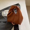 PU women's casual handbag in dumpling shape with sandwich pocket, shown in multiple colours.