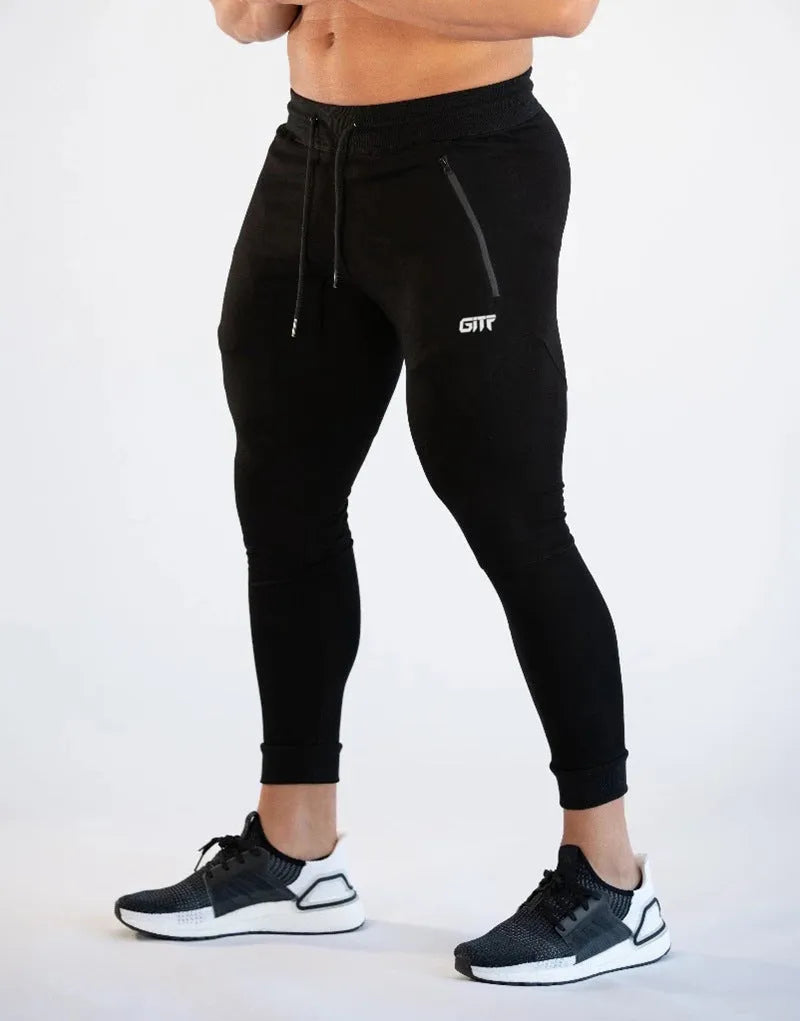 Men's camouflage quick dry jogging trousers in slim fit style from front view on plain background