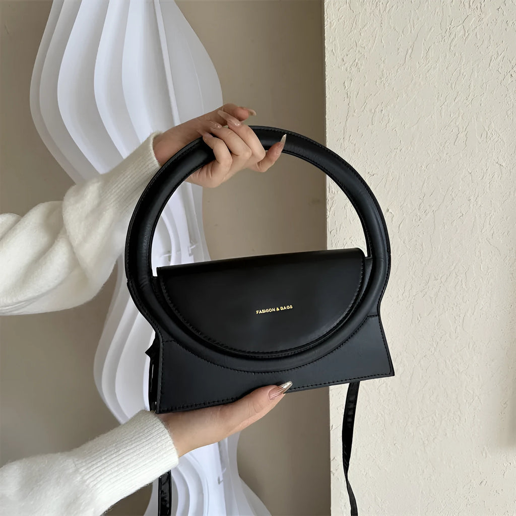Horizontal square messenger bag in black with stitching detail and shoulder strap