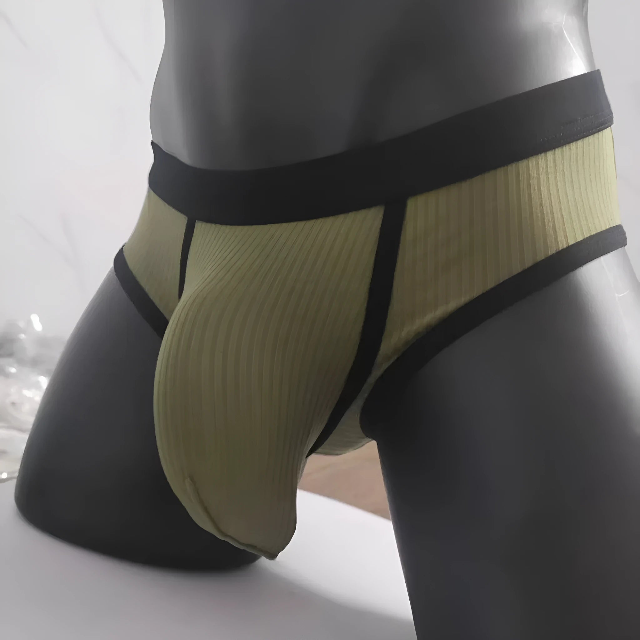 Men's solid colour U-shaped briefs in viscose fabric on a size chart background.