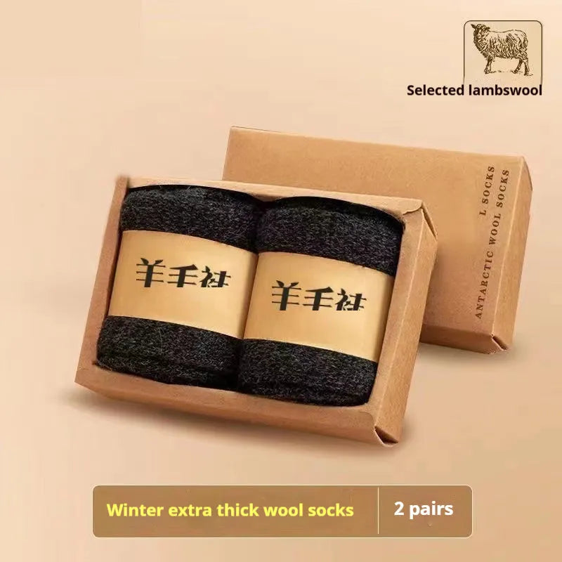 Pair of thick grey merino wool winter socks showing reinforced padded midsole and seamless toe.