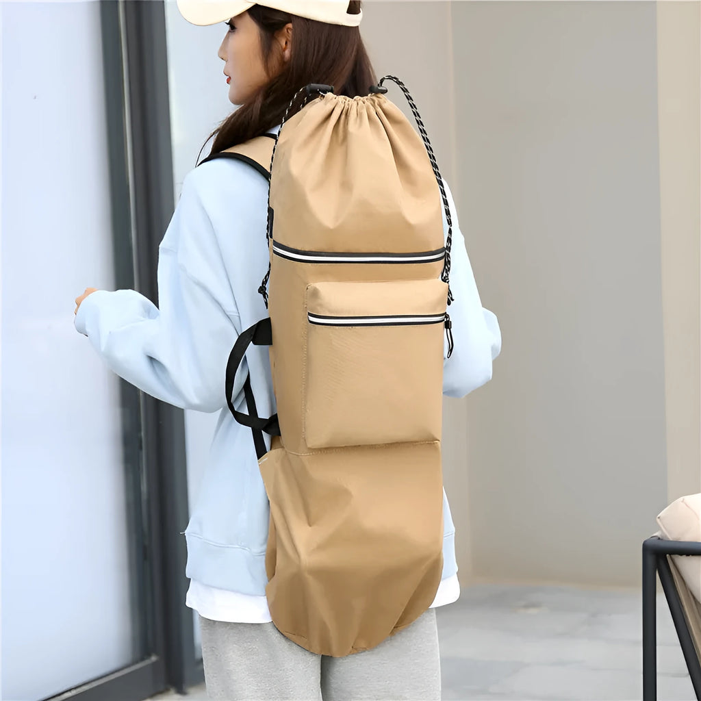 Black waterproof skateboard backpack with a longboard strapped to the side, showing padded shoulder straps.