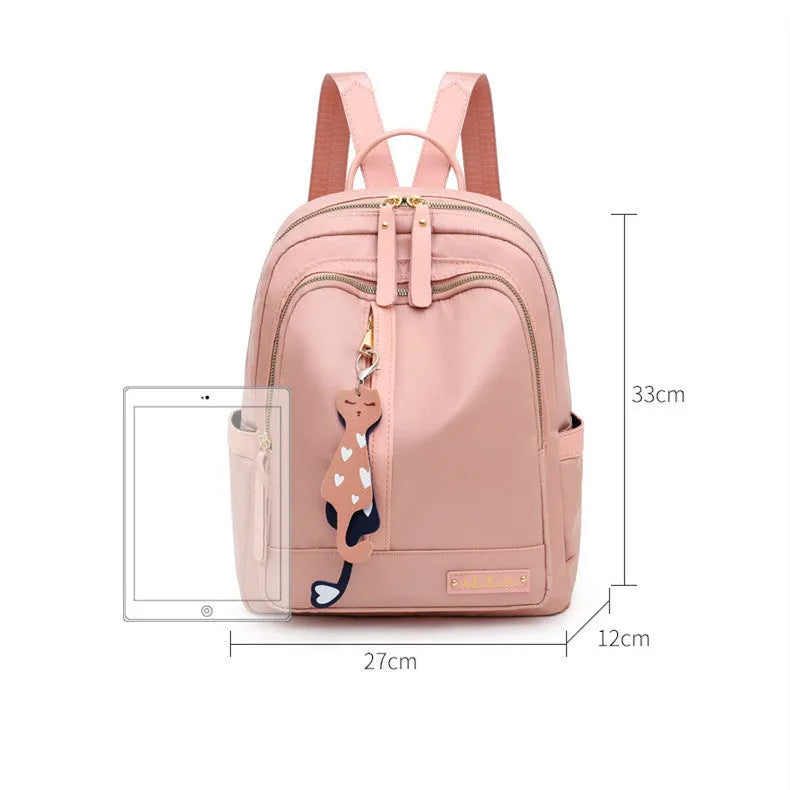 Black and pink casual nylon backpack with double straps, soft handle, and external pocket.