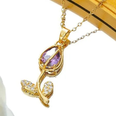 Gold tulip flower pendant necklace on an adjustable O-ring chain, showing electroplated finish.