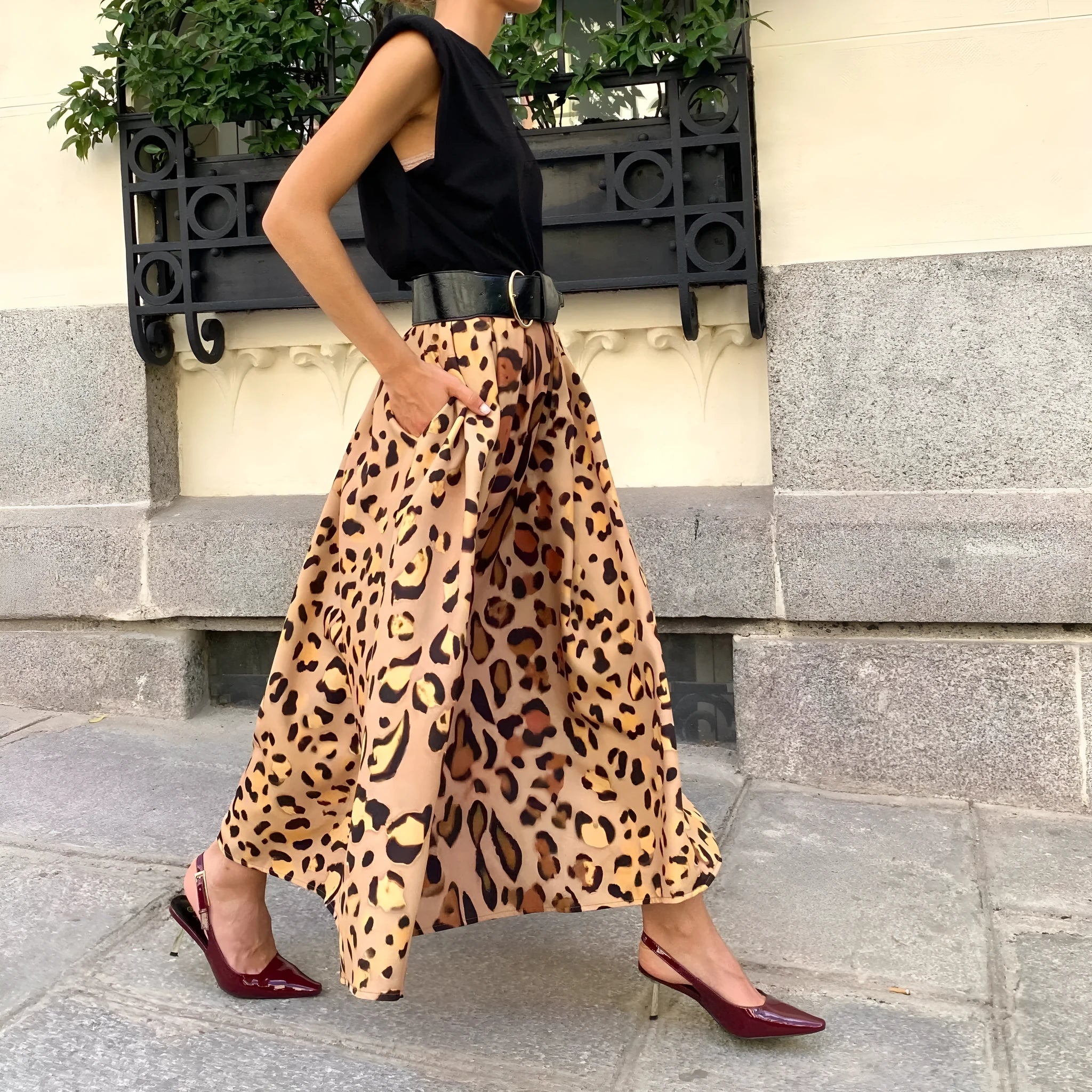 Brown leopard print women's A-line long skirt with a flared big hem, shown on a model.