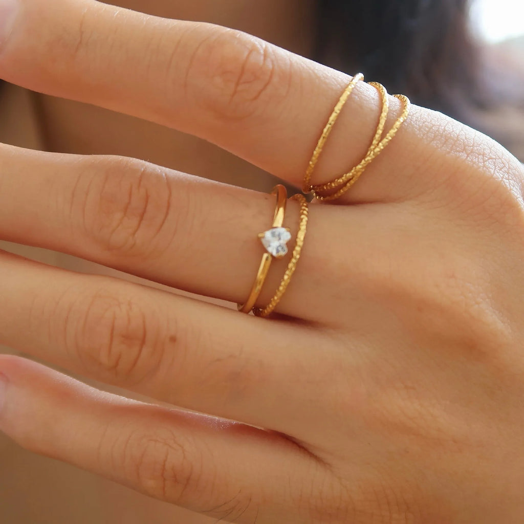 Golden love heart stainless steel ring showing heart shape design on female hand