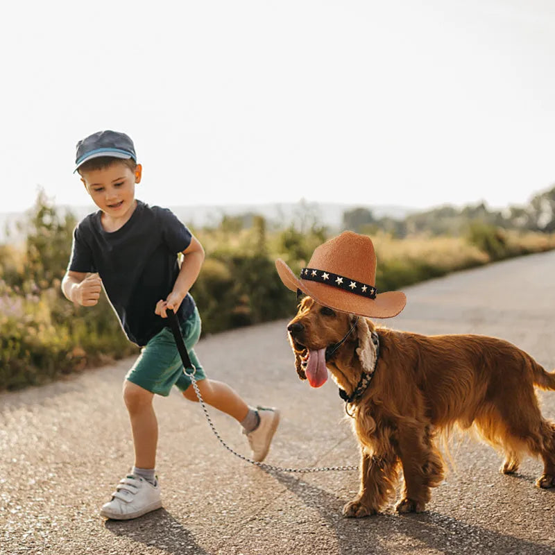 A black pet cowboy hat with a star decoration, shown with adjustable straps, sized for a cat or dog.