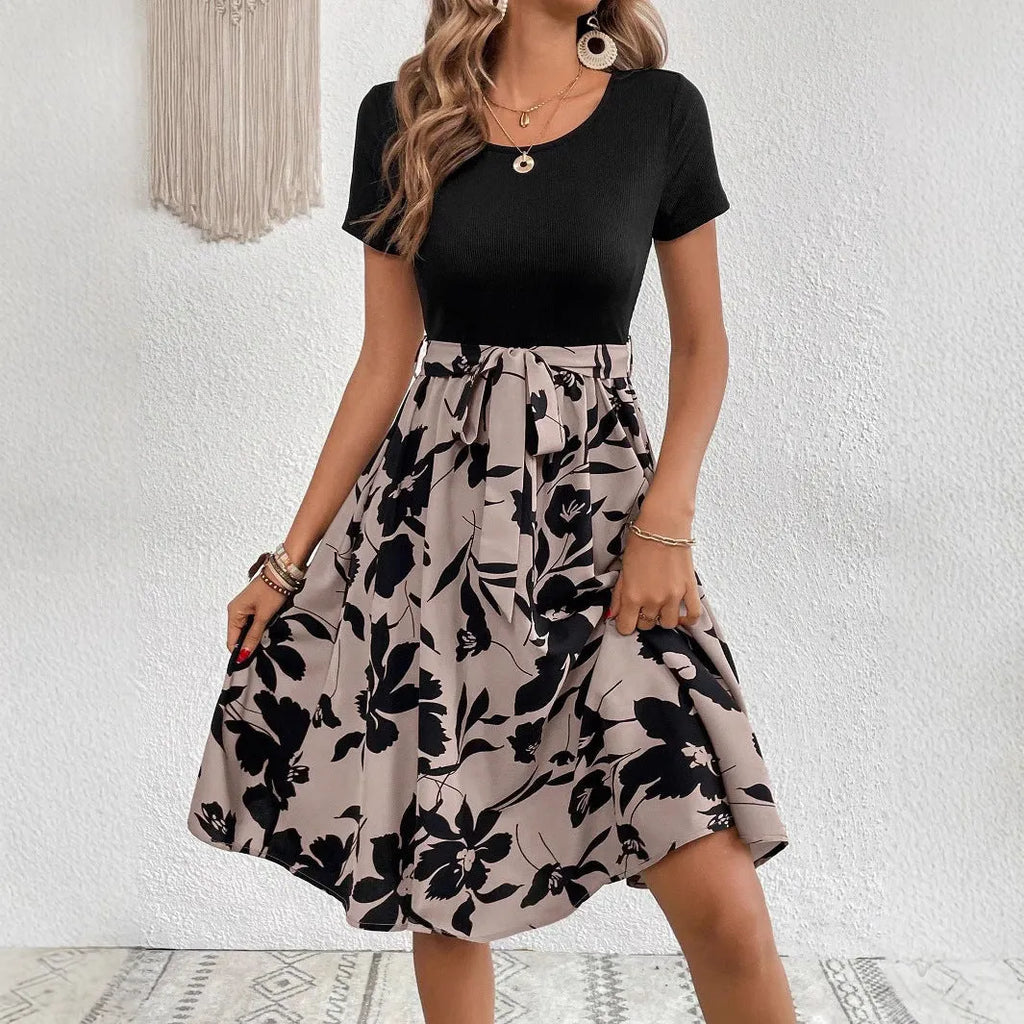 Khaki women's A-line dress with floral print, lace-up neckline, and a shoulder strap detail.
