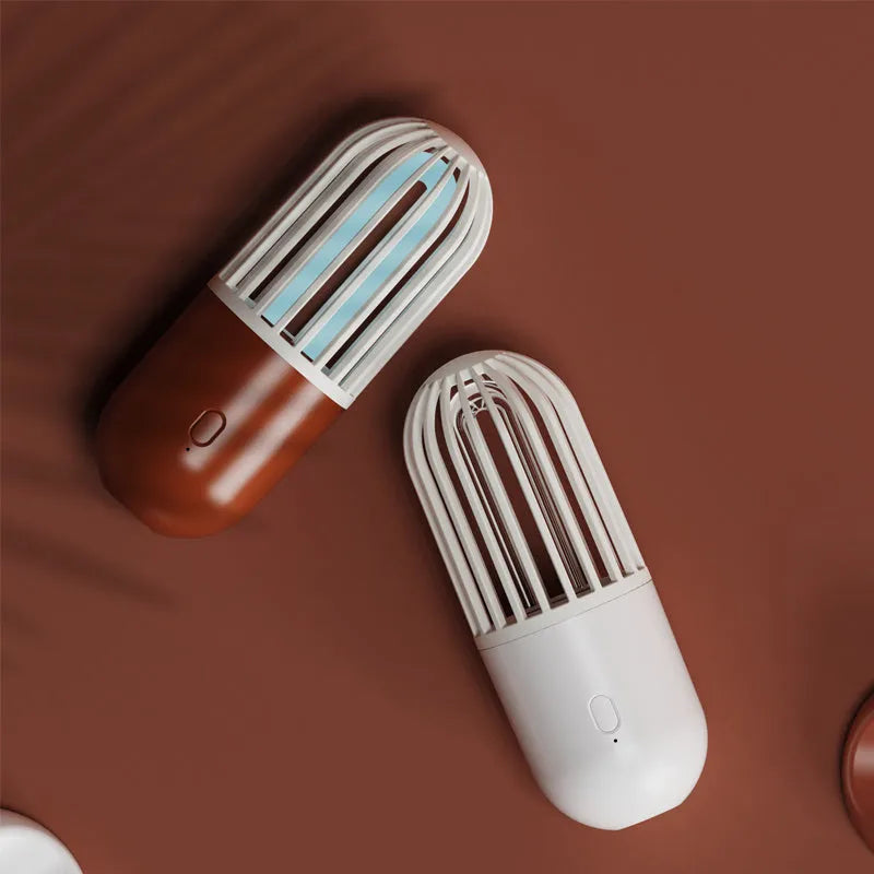 Portable capsule UVC disinfection lamp in four colours with dimensions 64x64x148mm