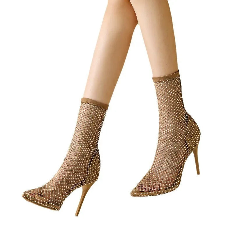 Gold high heel sandals with pointed toes, stiletto heels, and a mesh upper.