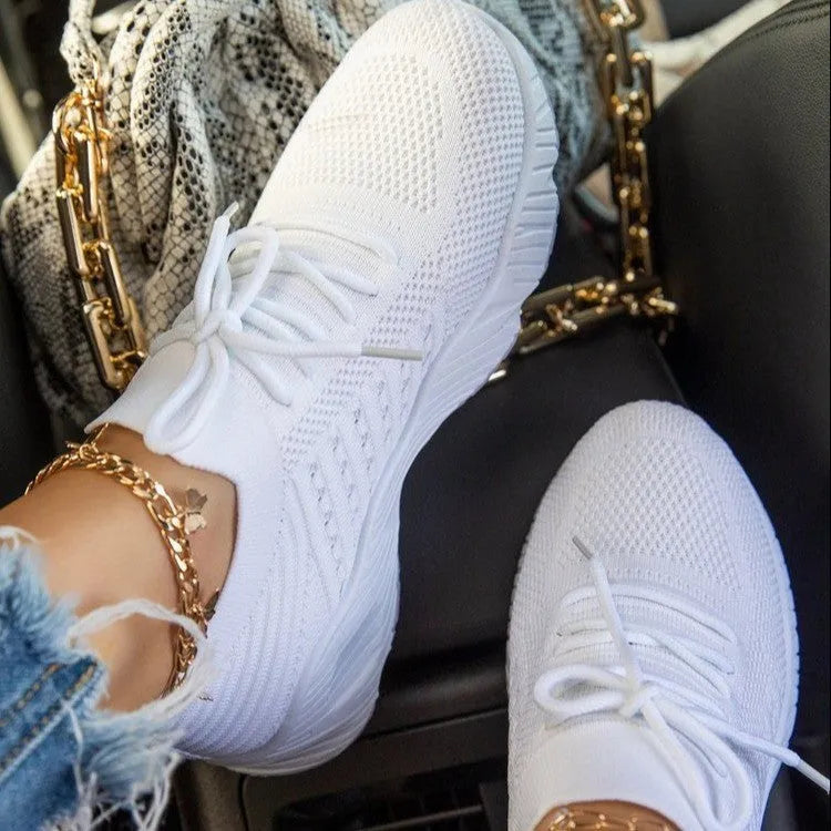 Women's chunky platform sneaker in a solid colour with a thick sole, shown from the side.