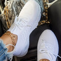 Women's chunky platform sneaker in a solid colour with a thick sole, shown from the side.