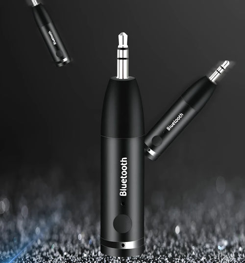 Black Bluetooth 5.0 audio receiver for car AUX or home stereo, shown with USB cable.