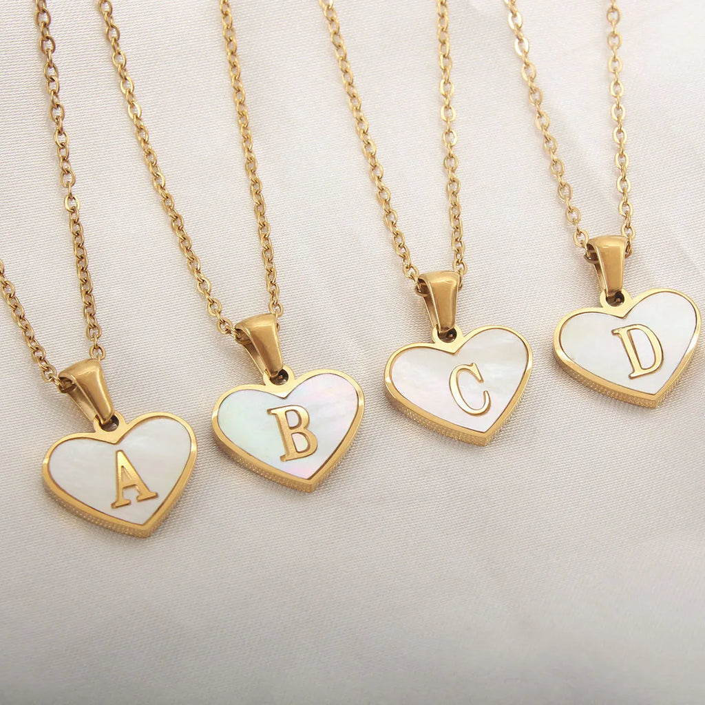Gold-plated heart necklace with white shell centre and personalised letter pendant on 45cm chain