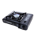 Black portable cassette stove with electronic ignition, 340x280x115mm, shown with black plastic box for camping and BBQ use