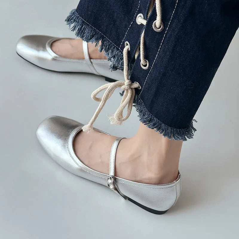 Retro brown Mary Jane flat shoes with a round toe and a single strap, showing the sheepskin upper.