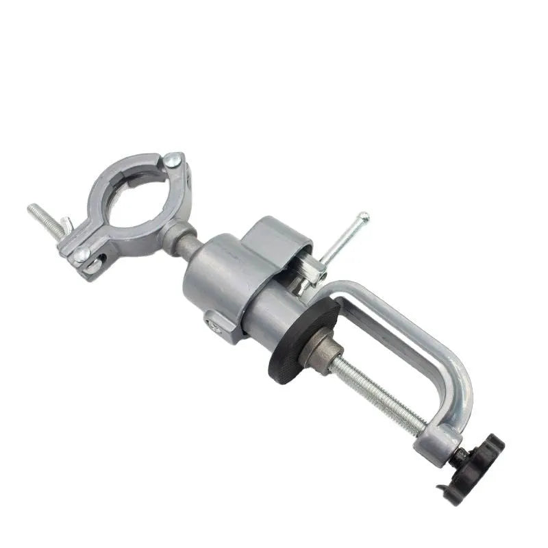 Clamp-on bench vise with a 360-degree rotating head and bracket pliers on a workbench.