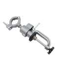 Clamp-on bench vise with a 360-degree rotating head and bracket pliers on a workbench.