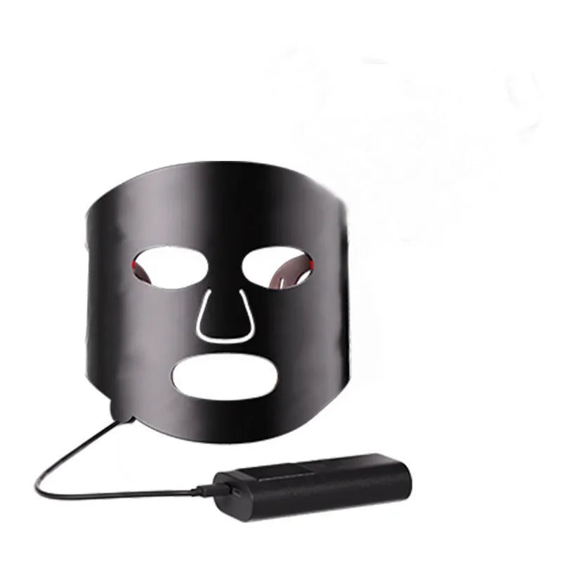 Black and white LED light therapy face mask with controller for home skin treatment.