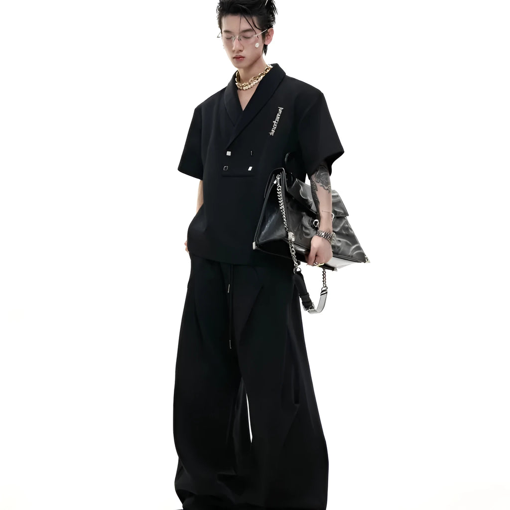 Men's dark grey cotton sports suit with padded shoulders, featuring a V-neck short-sleeve shirt and matching shorts.
