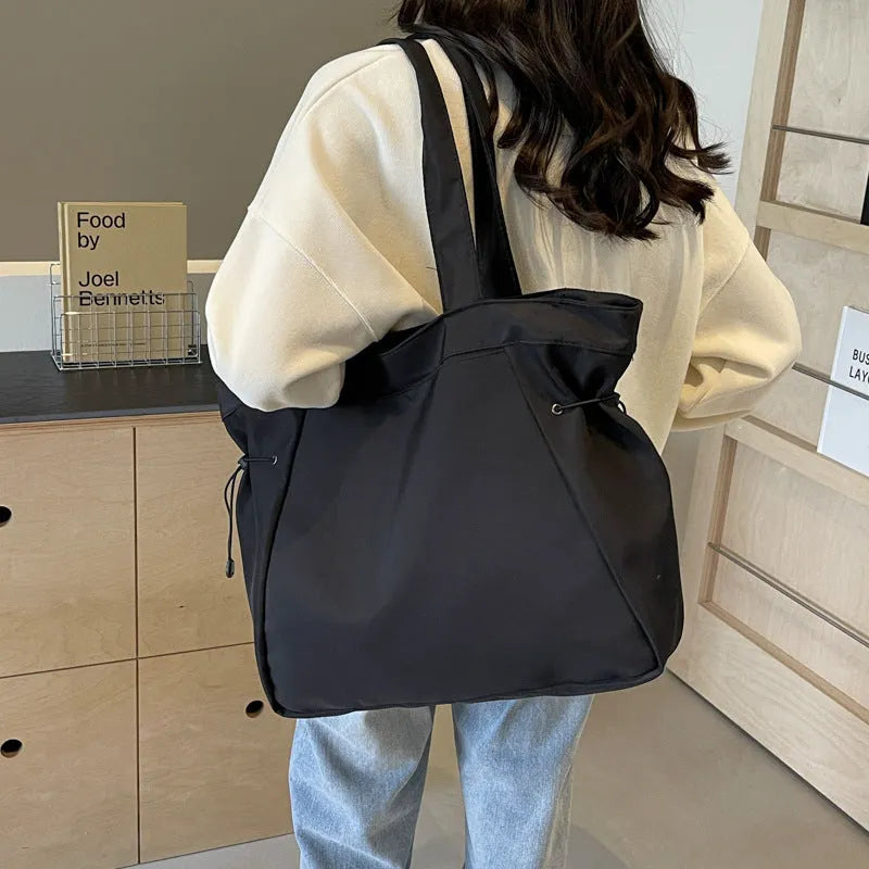 Soft foldable Oxford cloth shoulder tote bag in a street style, shown in various colours.