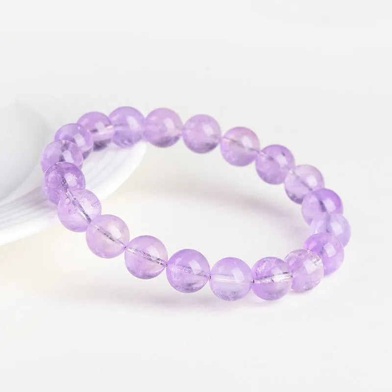 Lavender coloured amethyst crystal bead bracelet with round geometry shape and water ripple design.