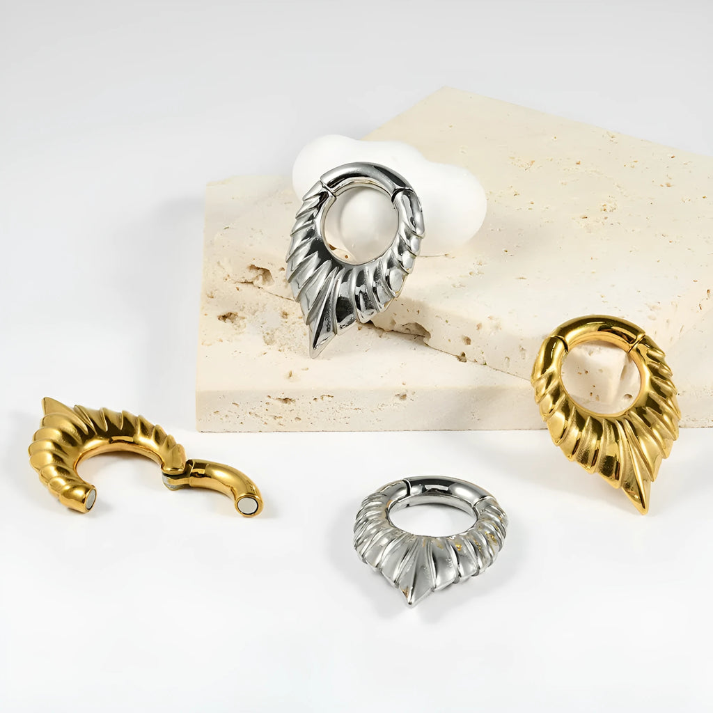 A stainless steel drop-shaped ear extender with totem detailing, shown on a plain background.