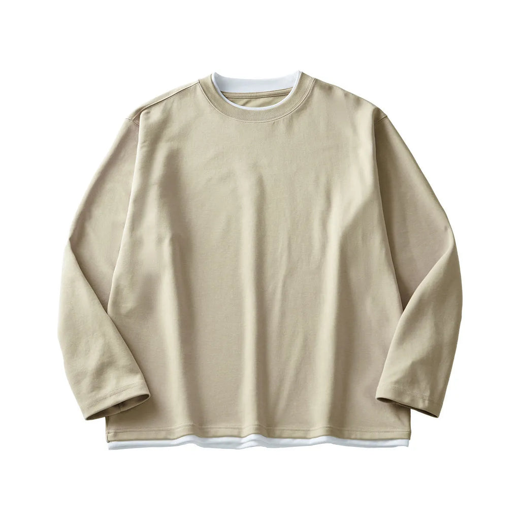 Man wearing a loose grey long-sleeved cotton blend T-shirt with a round neck.