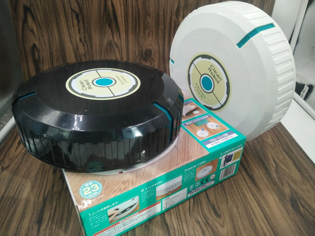 Black and white compact AC automatic sweeping robot vacuum cleaner on a wooden floor.