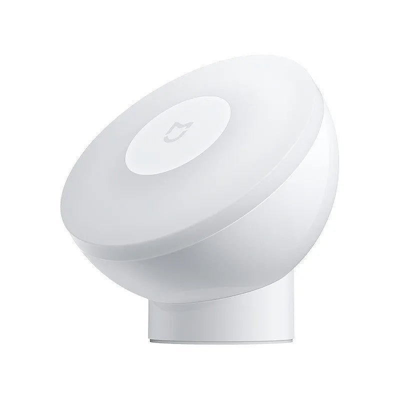 White modern bedside table lamp with human body induction and Bluetooth, shown on a nightstand.