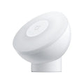 White modern bedside table lamp with human body induction and Bluetooth, shown on a nightstand.