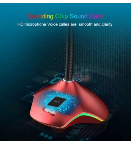 Black wired computer microphone with 3.5mm jack, blow-out sponge, and stand on a desk.