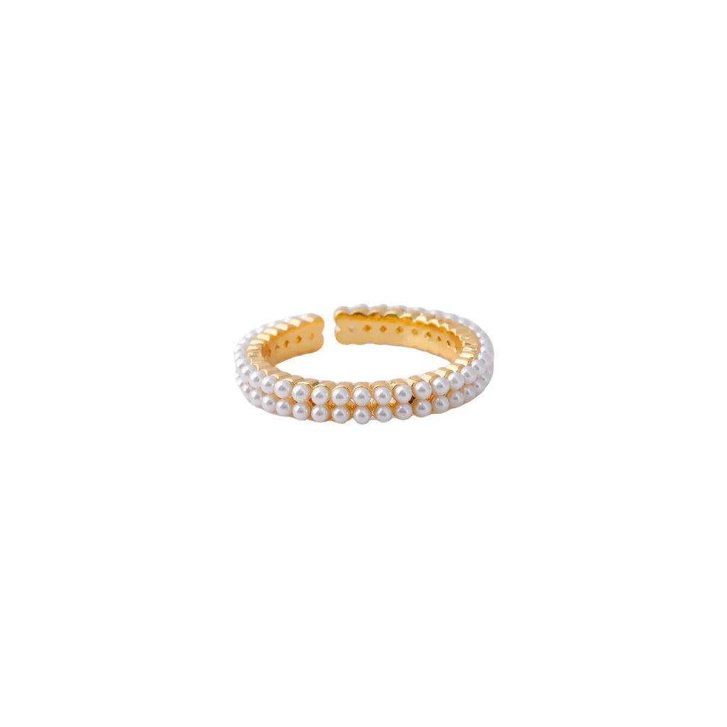 Gold electroplated pearl ring with open mouth geometric design on female hand