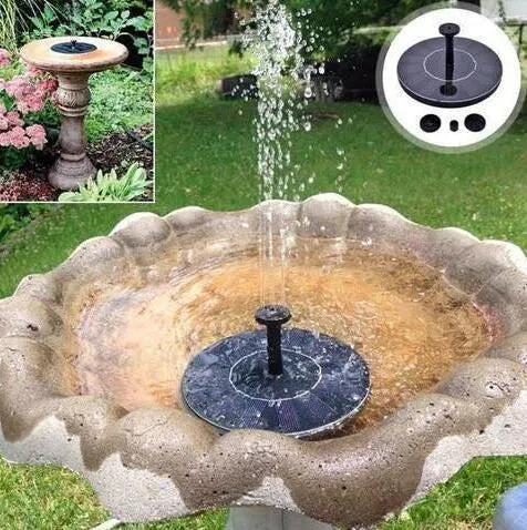 Black solar-powered fountain pump with multiple nozzles on a small pond or bird bath.