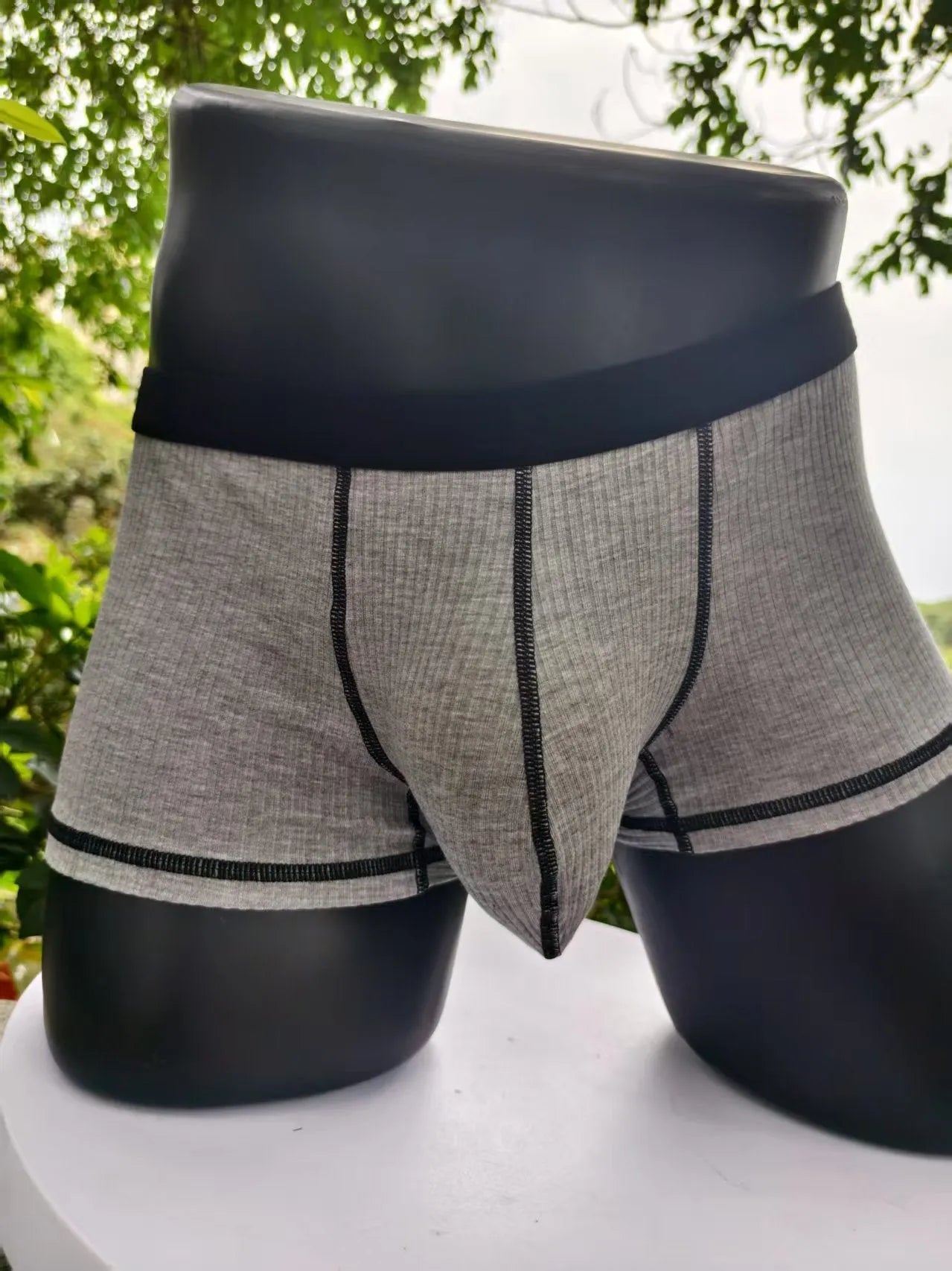 Men's solid colour breathable boxer shorts on a white background showing hip lifting design.