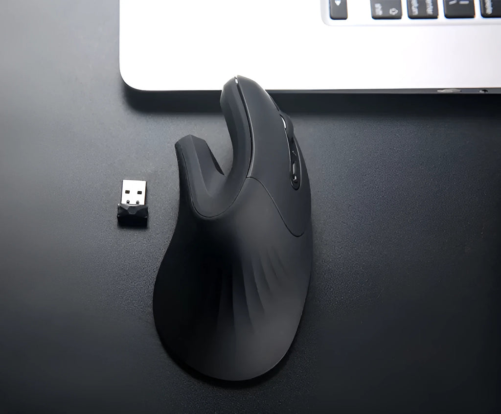 Wireless vertical mouse in black with ergonomic shape, six buttons, and diamond-pattern surface on a desk