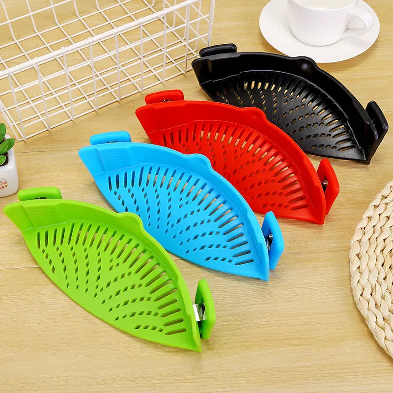 Silicone clip-on funnel strainer attached to a pot rim for draining liquids.