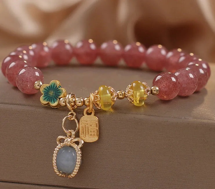 Red adjustable bracelet with strawberry quartz beads, alloy charm and rhinestone detailing